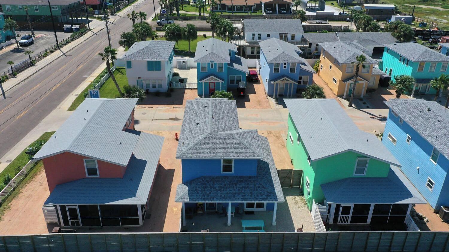 A residential area with houses featuring gabled roofs and front porches.