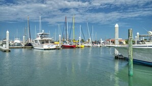 A marina with multiple boats docked at the piers.