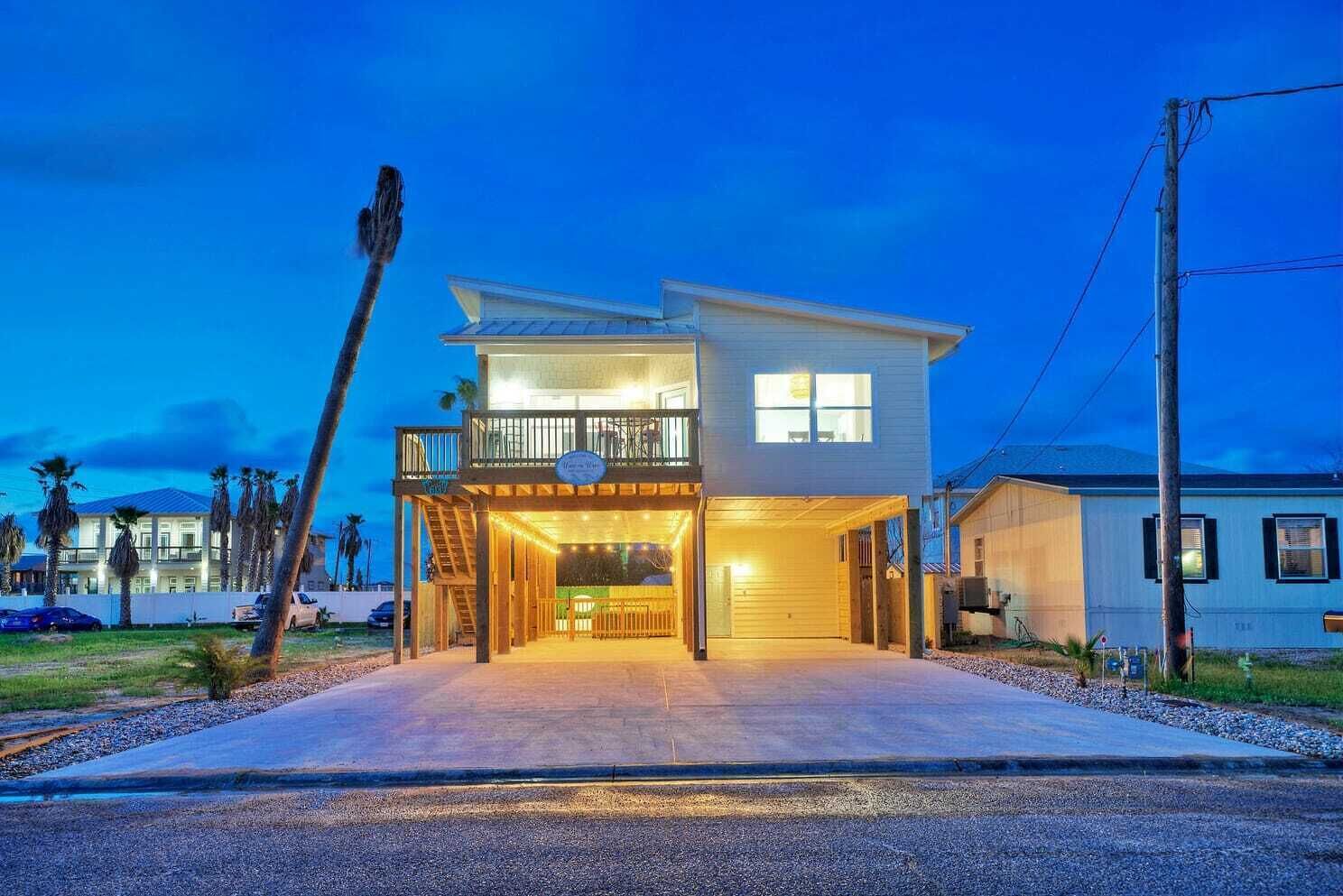 A two-story house with a covered front porch and a balcony.
