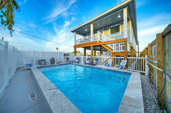 Enjoy a refreshing dip in the pool surrounded by a spacious balcony and deck area.