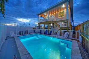 Enjoy a refreshing dip in the pool surrounded by lounge chairs.