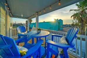 Relax in a tranquil outdoor setting with a round table and comfortable seating, surrounded by a stunning view.