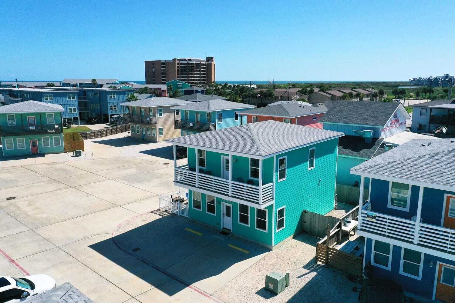 A cluster of small, colorful buildings with a flat roof and a central courtyard.