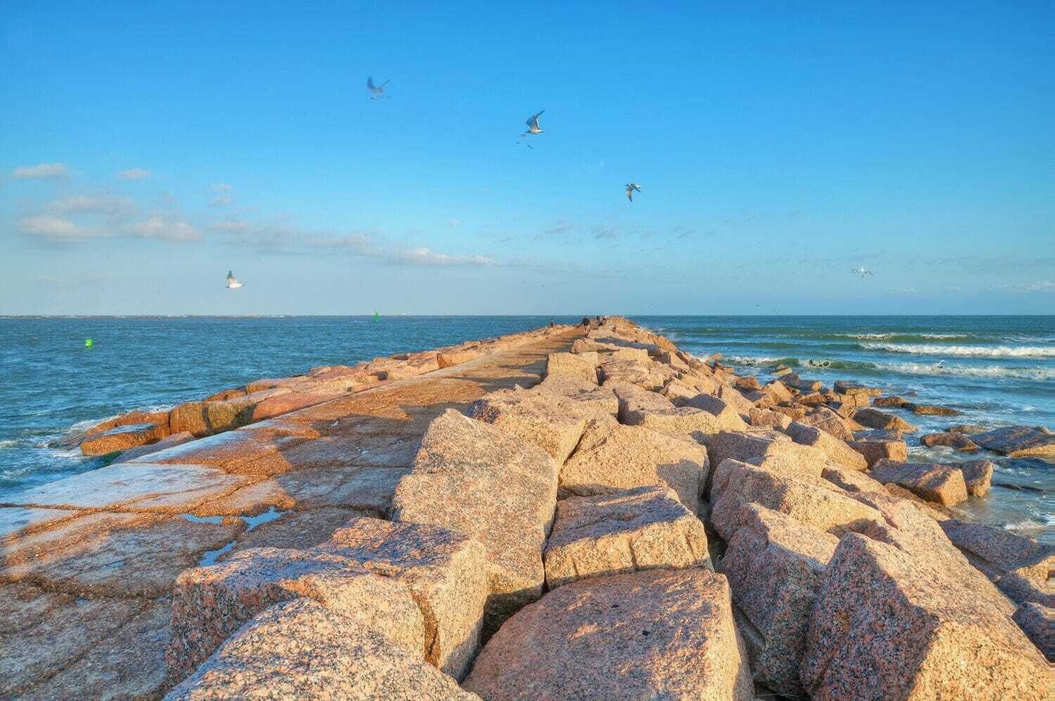 A rocky shoreline with waves crashing against the rocks.