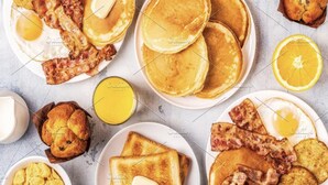 A breakfast spread with pancakes, bacon, toast, muffins, and orange juice. - Hotel Bella Vista New Delhi-walk from New delhi railway station (New Delhi)