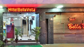 The entrance of Hotel Bella Vista with a neon sign, a welcome sign, and a fire assembly point sign. - Hotel Bella Vista New Delhi-walk from New delhi railway station (New Delhi)