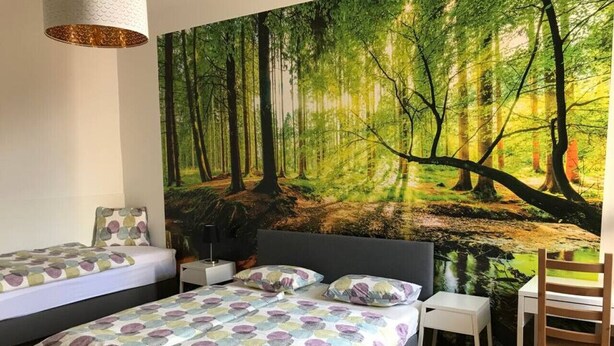 A bedroom with two beds, a desk, and a chair. - Cozy 2 bedroom Apart with balcony in Ottakring (Vienna)