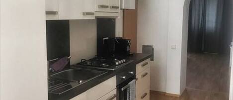 Een koelkast, een oven, een kookplaat, een vaatwasser