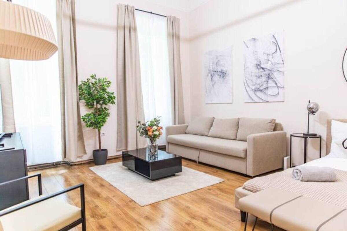 A modern living room with a sofa, a coffee table, a lamp, and artwork on the wall.