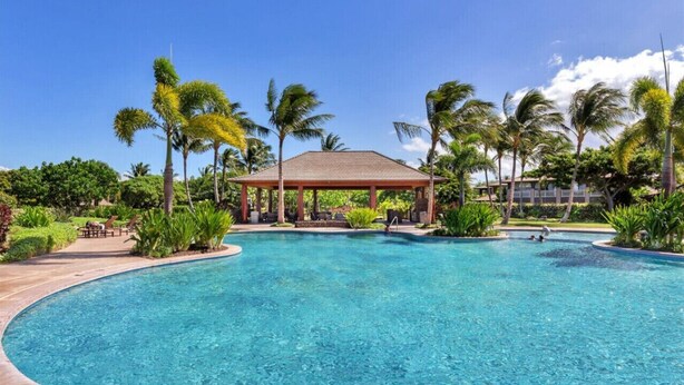 A clear blue pool with a gazebo, palm trees, and a well-maintained garden. - Golf Course Front - Upgraded - Kulalani Mauna Lani (Waimea)