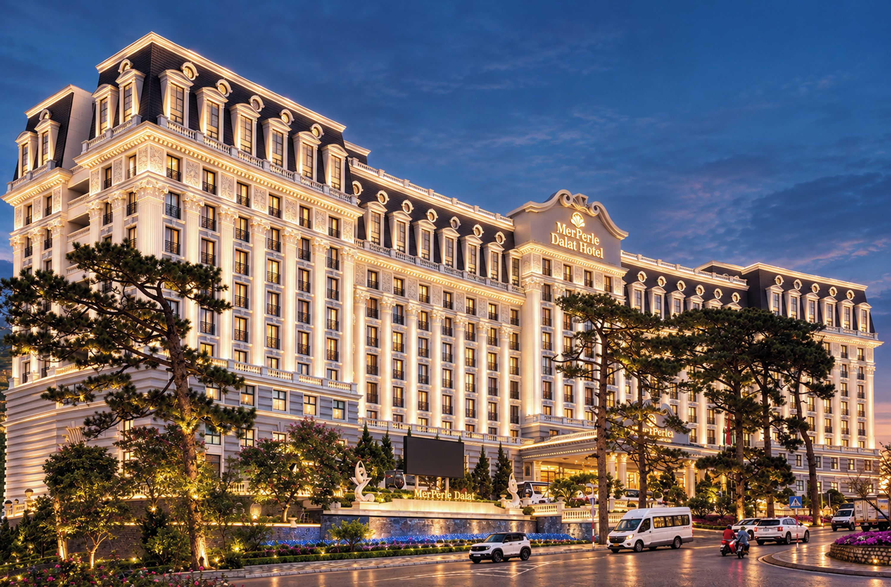 A large, multi-story hotel with a classic architectural style, featuring a prominent entrance and a well-lit facade.