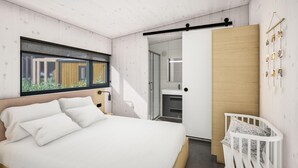 A modern bedroom with a bed, a crib, a large window, and a sliding door leading to a bathroom. - Lodge in Arcen by Recreational Lake (Arcen)