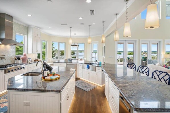 A spacious kitchen with a central island, large windows, and a view of the outdoors. - Pickleball, Mini Golf, Waterfront with Dock, Pool (St. Augustine)