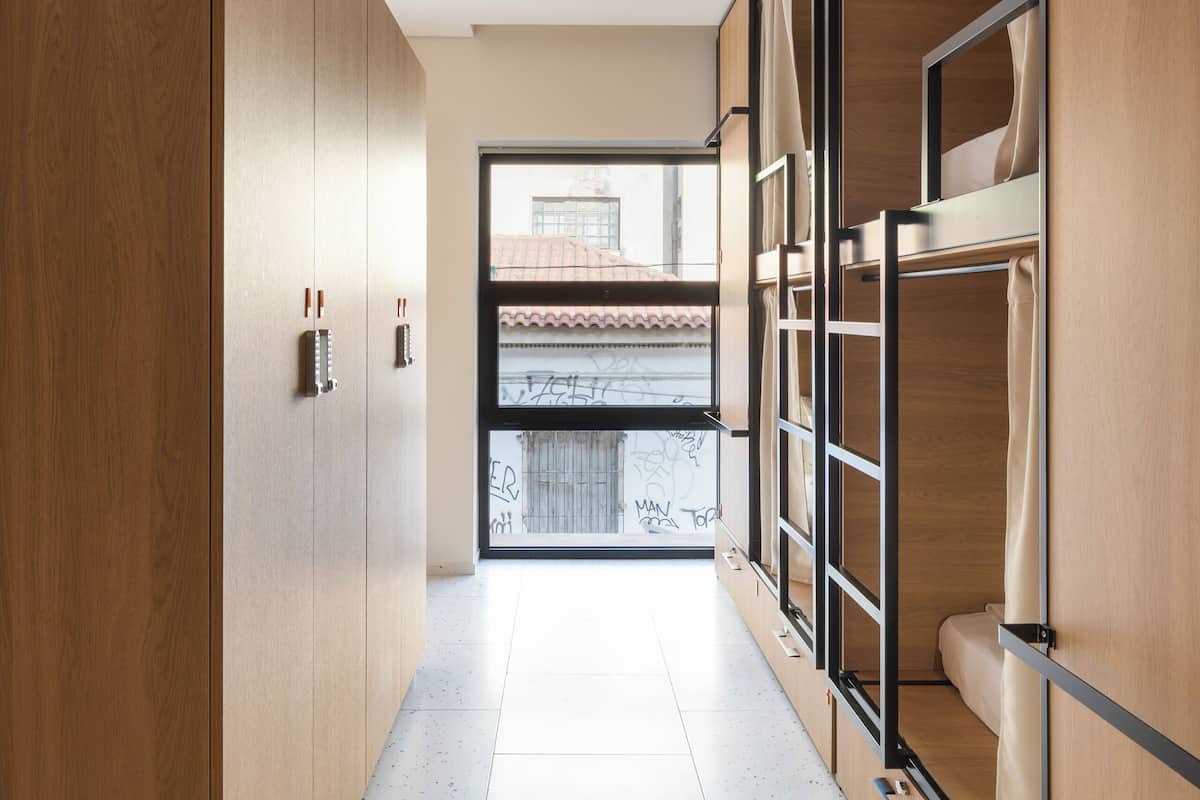 A modern hallway with wooden cabinets and a large window.
