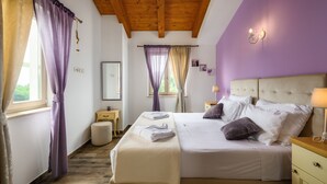 A bedroom with a bed, bedside tables, a nightstand, a window with curtains, and a wooden ceiling. - Villa Stella Polaris with pool in Višnjan, Istria (Srebrnići)