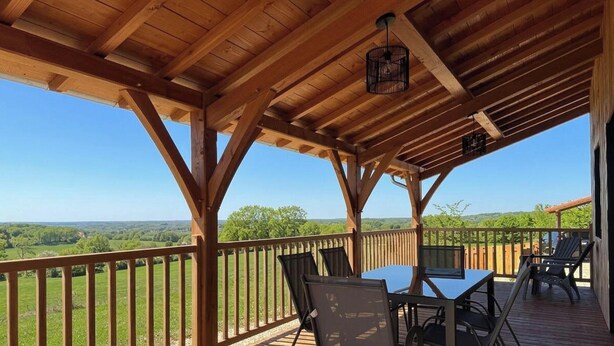A wooden deck with a table and chairs, overlooking a scenic landscape. - Modern house in the heart of Green Périgord with pets allowed (Preyssac-d'Excideuil)