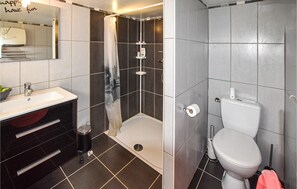 Bathroom features a shower, sink, toilet, and bidet.