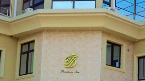 A building with a beige facade, a logo with a crown above the text "Residence Inn," and multiple windows. - TD RESIDENCE INN (Ijebu Ode)