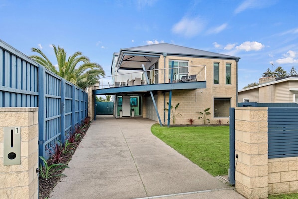 A modern two-story house with a covered porch and a garage.