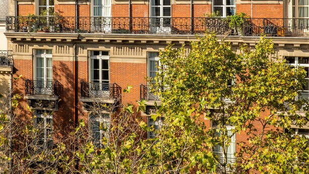 A row of townhouses with multiple balconies, brick facades, and a clear sky. - Soulful Fusion, by Veeve (Paris)