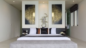 A large, modern bedroom with a large bed, two wall-mounted artworks, a decorative sculpture, and a glass shower enclosure. - Spice : 3 Bed Sublime Luxury Five Star Villa (Koh Samui)