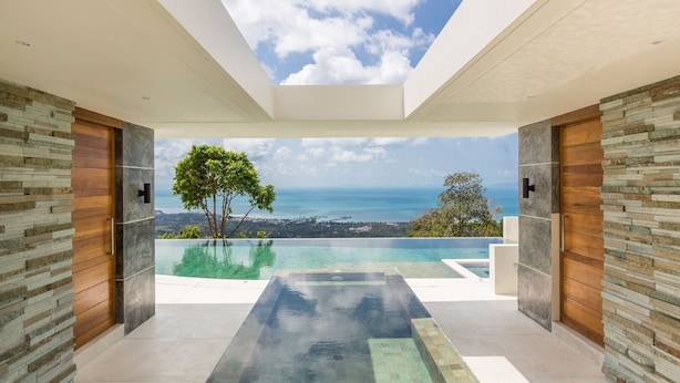 A modern interior with a large glass ceiling, a view of the ocean, and a pool area. - Spice : 3 Bed Sublime Luxury Five Star Villa (Koh Samui)