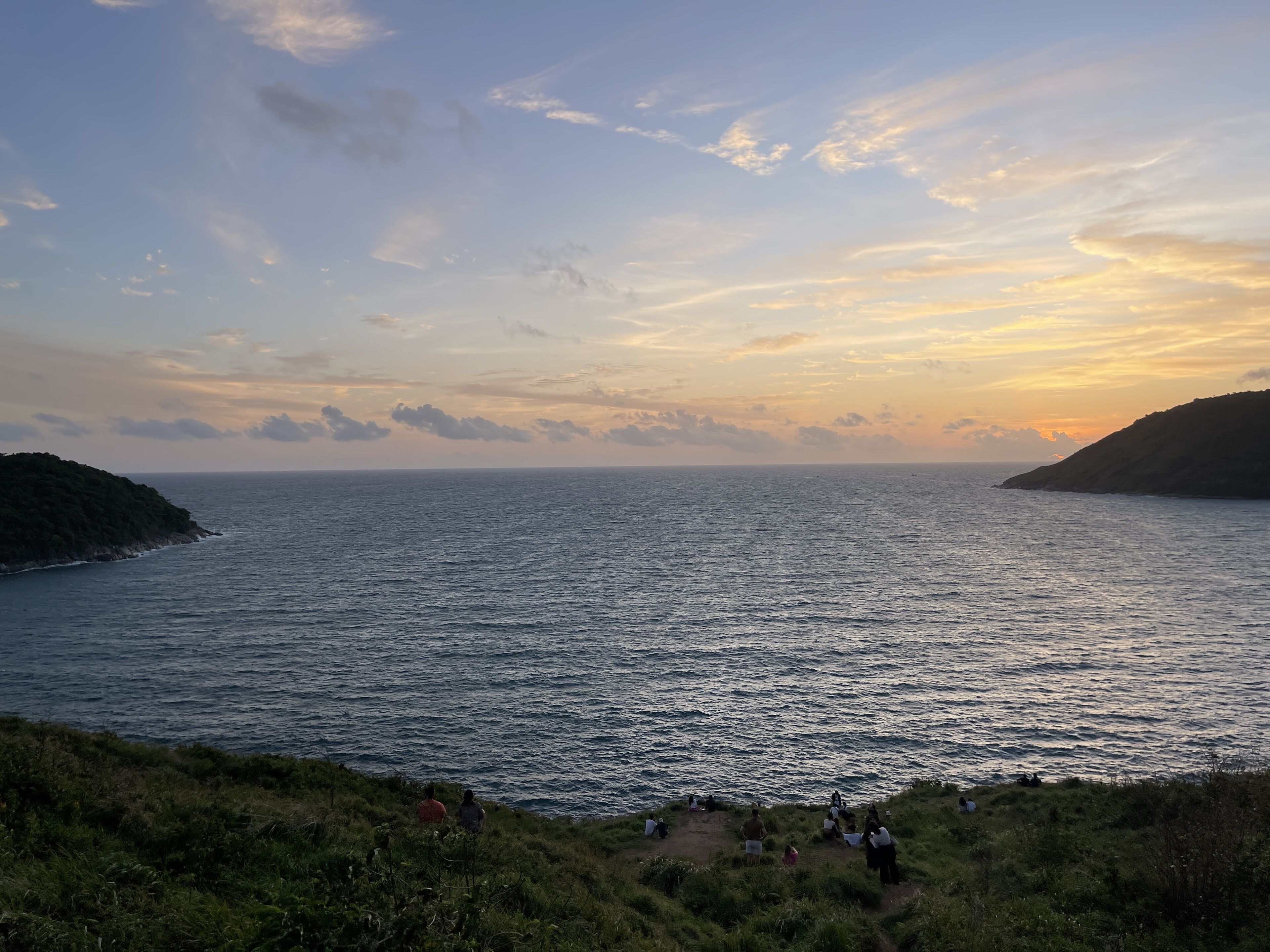 A coastal landscape with a clear view of the sea and a hilly terrain.