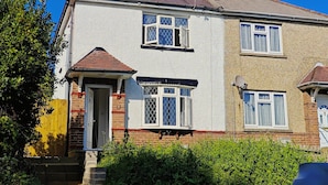 A two-story house with a brick facade, a tiled roof, and a front door with a small porch. - 4-bed House in Southampton Ideal For Contractors (Southampton)