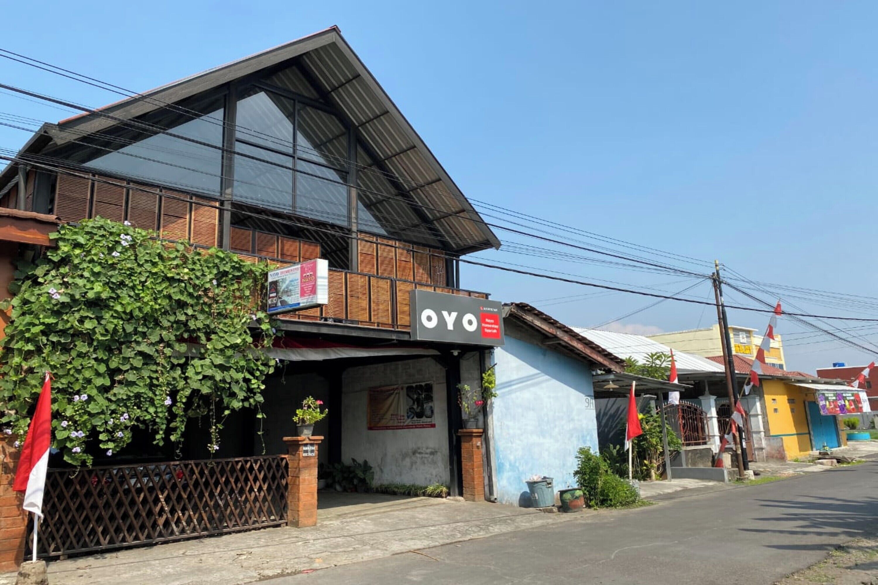 A building with a sign that reads "OYO" and a large window.