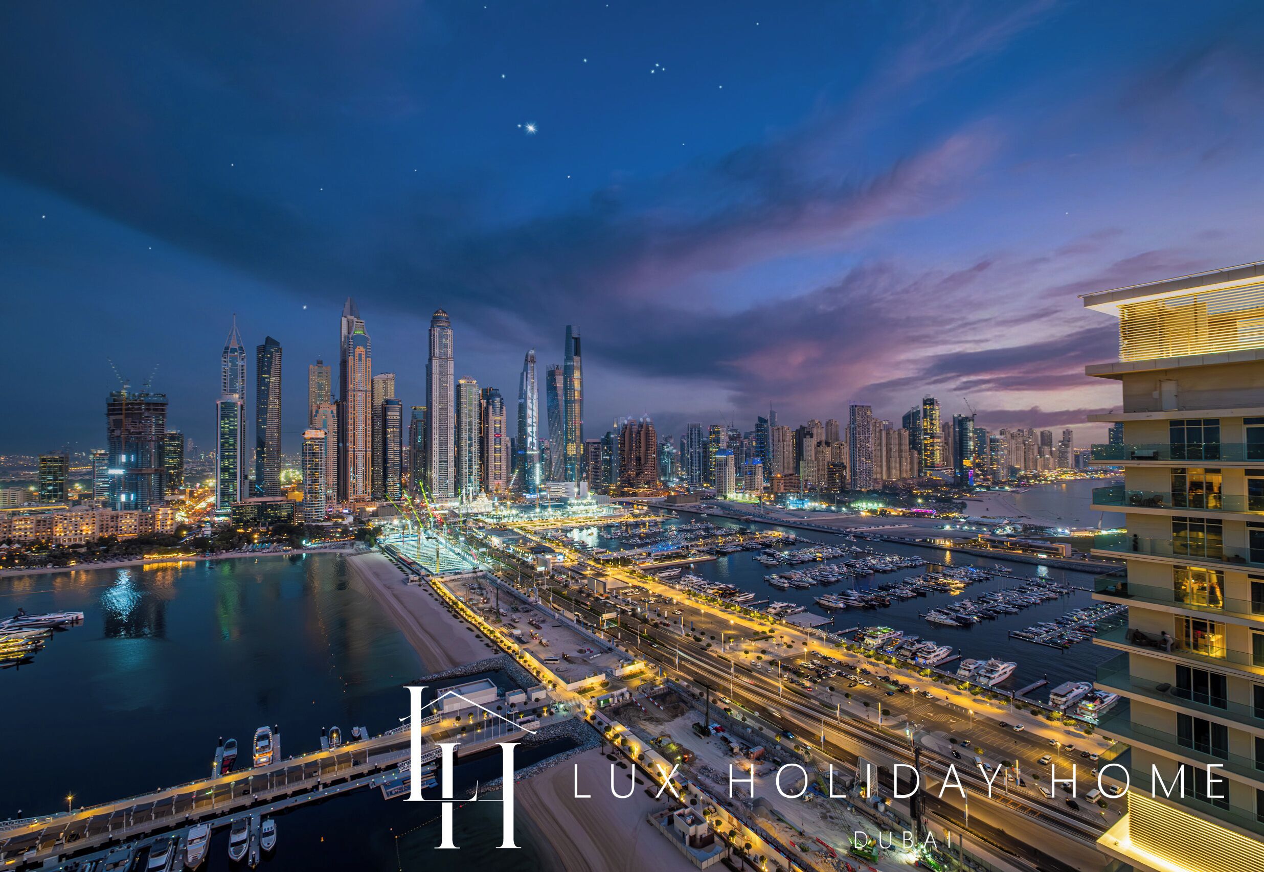 A nighttime cityscape with a marina and high-rise buildings.