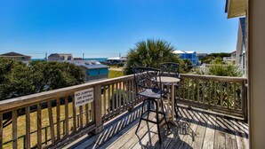 A wooden deck with a sign prohibiting jumping or diving from the deck. - ☀️Atlantic Views- Beautiful 8BR Home with Private Pool (Kure Beach)