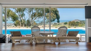 A room with a view of a pool and landscape. - Encounter Blue Victor Harbor Retreat: Secluded Pool (Waitpinga)