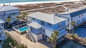 A beachfront property with a swimming pool, multiple buildings, and a view of the ocean. - 🌊3 Generations Beach House | Beachfront | Private Pool | Sleeps 17 (Santa Rosa Beach)