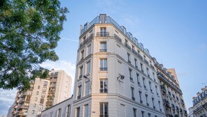 A multi-story building with a classic architectural style, featuring balconies and large windows. - Residence Le Belleville (Paris)