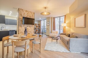 Deluxe Apartment, 1 Bedroom, Kitchenette | Living area | 96-cm Smart TV with cable channels - Residence Le Belleville (Paris)