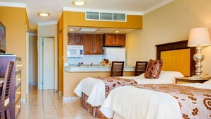 A hotel room with two beds, a kitchenette, a dining area, and a bathroom. - The Best of Cabo San Lucas! (cabo san lucas)