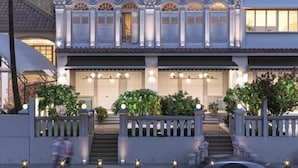 A multi-story building with a traditional facade and a modern upper section. - Recharge Residences  (Singapore)