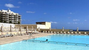 A swimming pool with lounge chairs and a lifeguard tower. - Luxury Seafront 3BR w/Pool by ArcoCollection (Sliema)