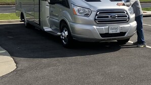 A silver RV with a Ford logo, parked on a road with a license plate from Southland RV. - 2020 Leisure Travel Rv Wonder at Boothbay Harbor, Maine!   (Boothbay)