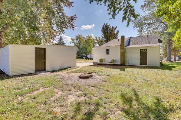 Two small, single-story buildings with a dirt yard and sparse grass. - Modern Northfield Cottage w/ Yard! (Northfield)