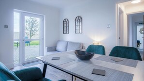 A modern dining area with a table, chairs, and a bowl.