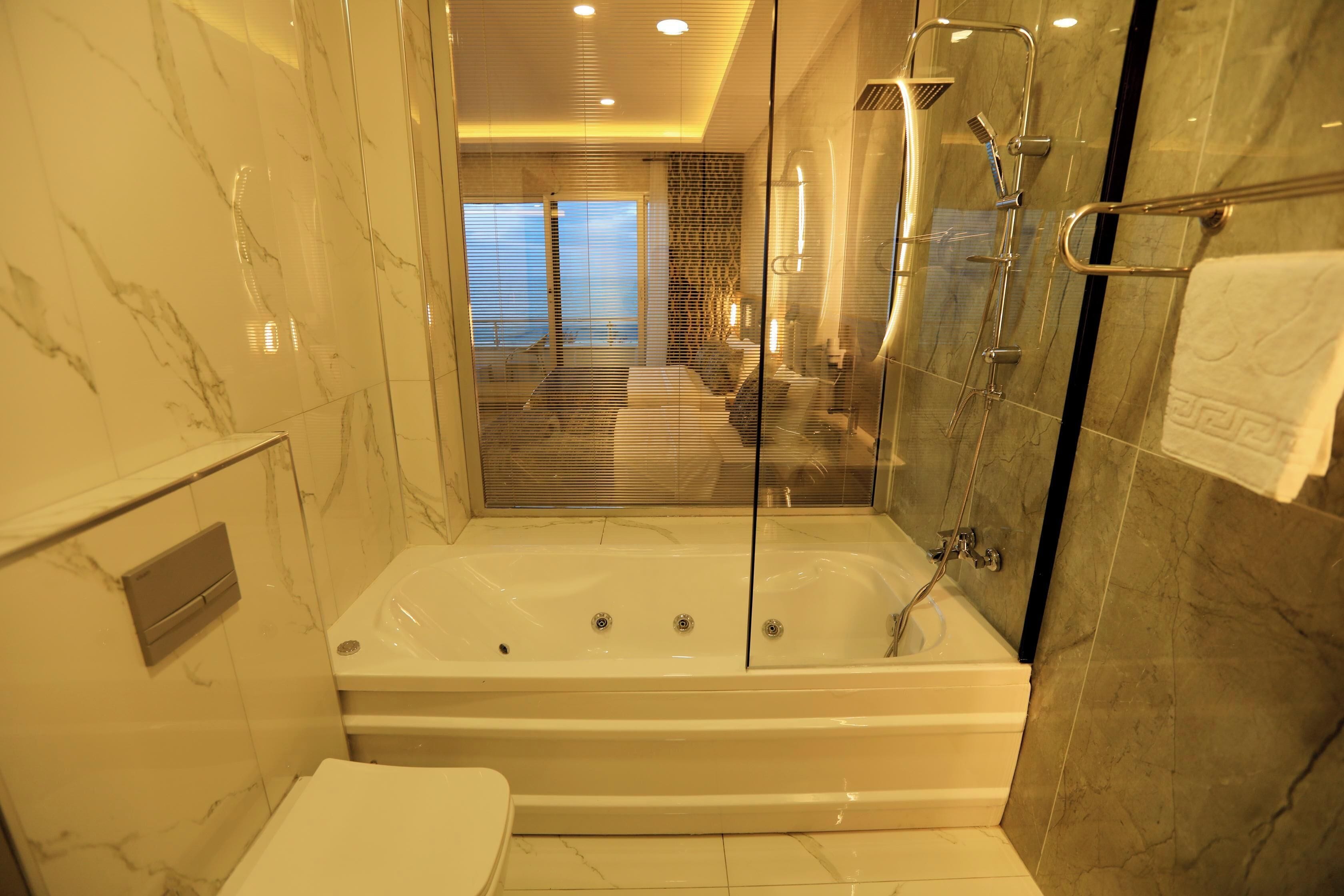 deluxe room triple, lake view with balcony | bathroom | free toiletries, hair dryer, slippers, towels