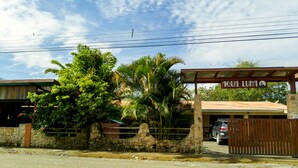 A gated property with a sign reading "AQUA LUNA" and a covered parking area.