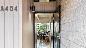 A hallway leading to a dining area with a view of the outdoors. - Top Floor updated condo, oceanview, AC, walk to shops, dining, and beach (Kihei)