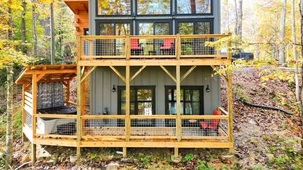 A multi-level wooden cabin with balconies, surrounded by autumn foliage. - Harper’s Hideaway- Close to Downtown Gatlinburg, Hot Tub, Guest Favorite! (Gatlinburg)