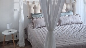 A bedroom with a bed, a bedside table, and a canopy. - Enrica apartment, elegant, near the lake historic center free parking (Lovere)