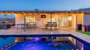 A covered outdoor patio with a pool, a barbecue area, and a dining setup. - 5 min to Old Town-Sleeps 12-Heated Pool-King Bed-Ping Pong-Fire Pit (Scottsdale)