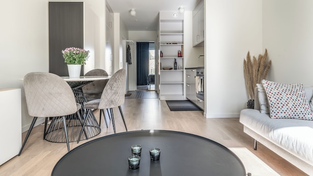 A modern living room with a dining area, a sofa, and a coffee table. - 2 Bedroom Cozy City Apartment in Bromma (Bromma)