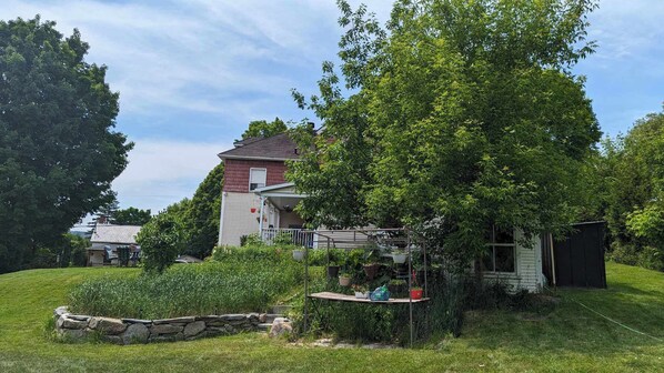 A residential house with a front porch, a small garden, and a garage.