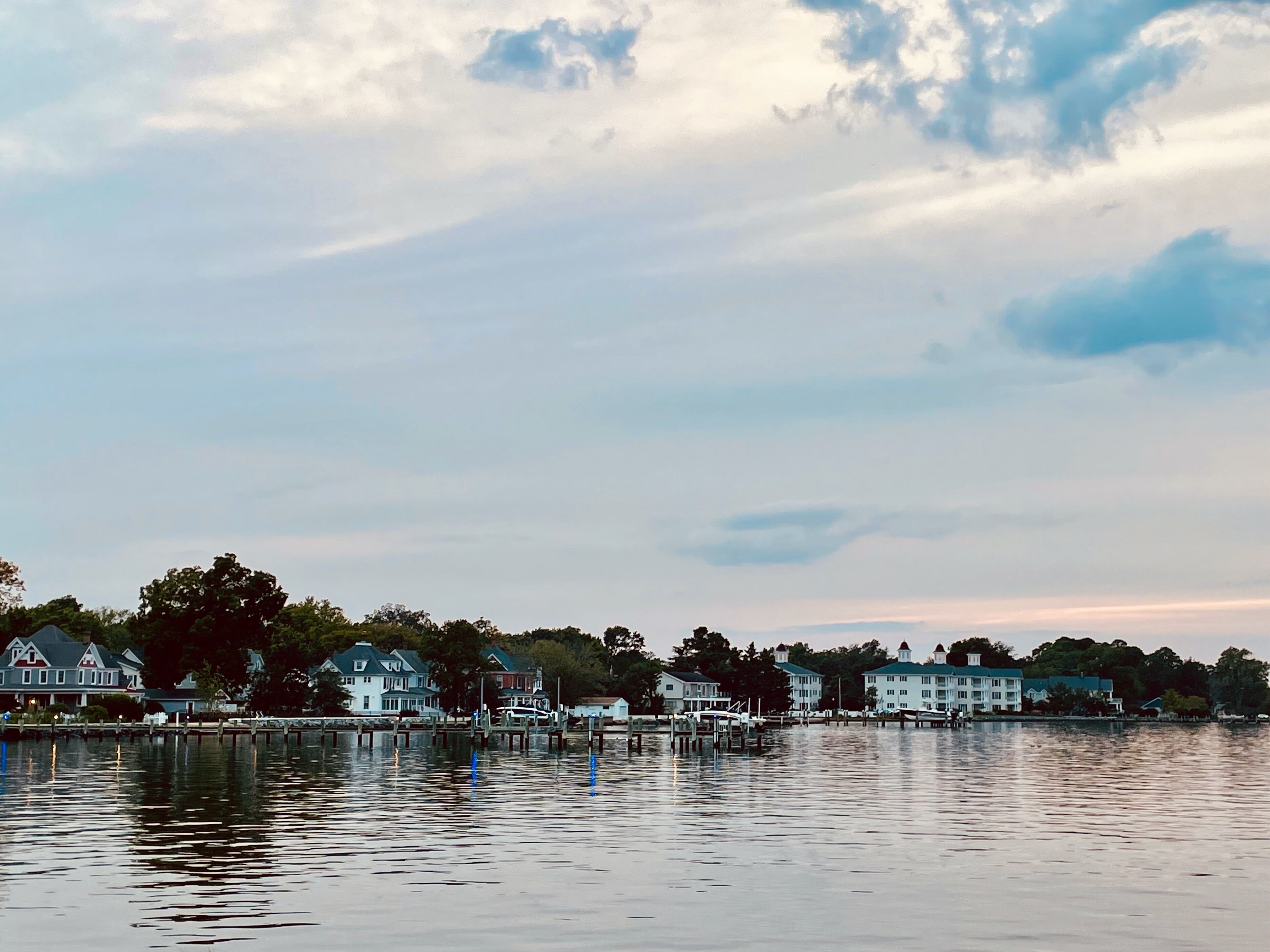 A waterfront view with several houses and docks.
